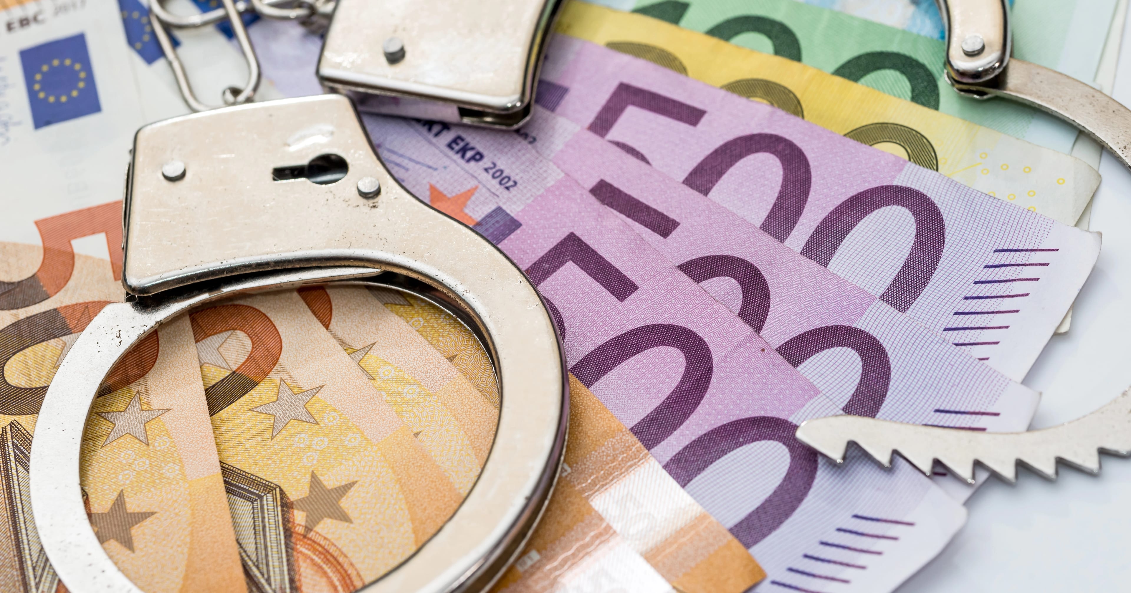 Police,Handcuffs,With,Euro,Eu,Money,,Economic,Crime,,Fraud