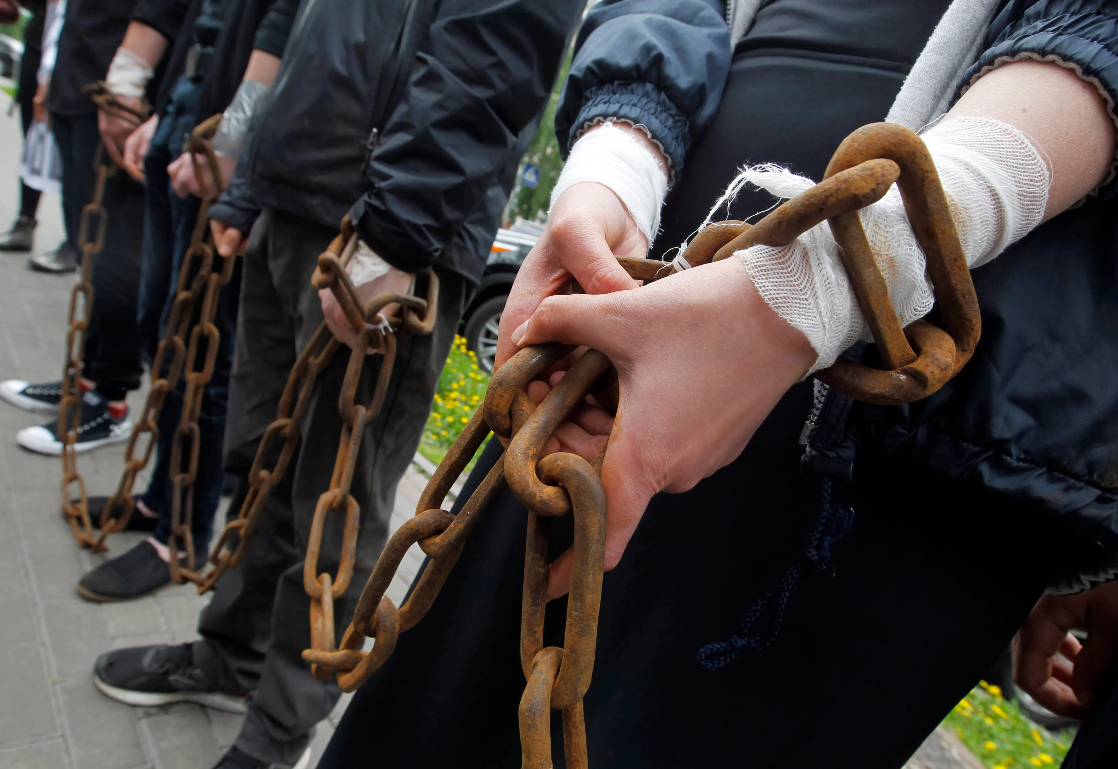 Group,Of,People,Stand,With,Chained,Hands,Close-up